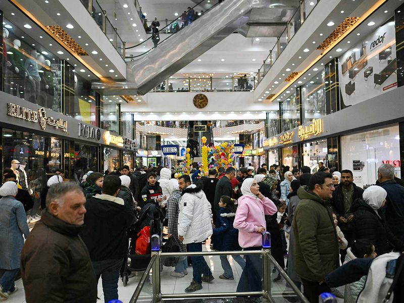 People shop at a shopping mall in the town of Al Dana, near Sarmada, in the northern Syrian province of Idlib. 