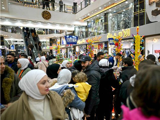 People shop at a shopping mall in the town of Al Dana, near Sarmada