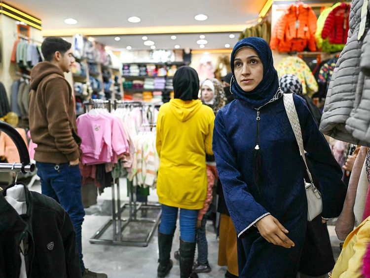 People shop at a store in the town of Al Dana, near Sarmada, in the northern Syrian province of Idlib. 