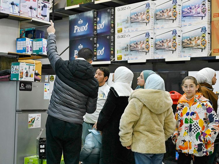 People shop at a store in the town of Al Dana, near Sarmada, in the northern Syrian province of Idlib. 